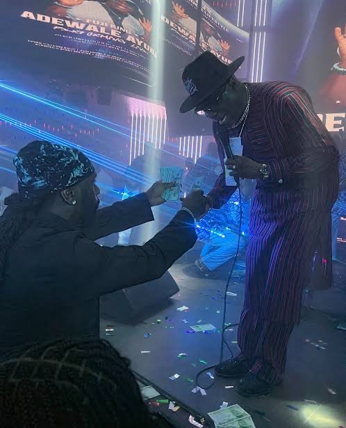 Veteran Singer Adewale Ayuba Soaked in Dollars as Burna Boy Rains $10,000 on Him at Club